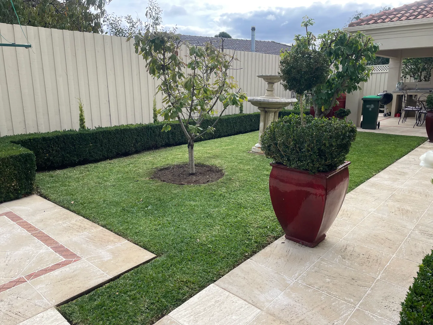 A landscape picture of a yard with lawn mowed by Peter's Mates Rates Mowing